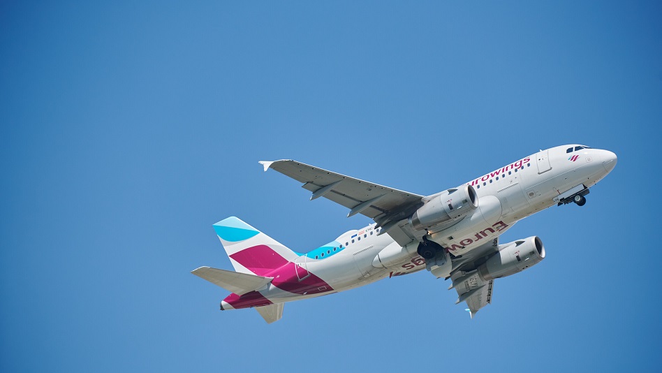 A Eurowings plane flies through the air.