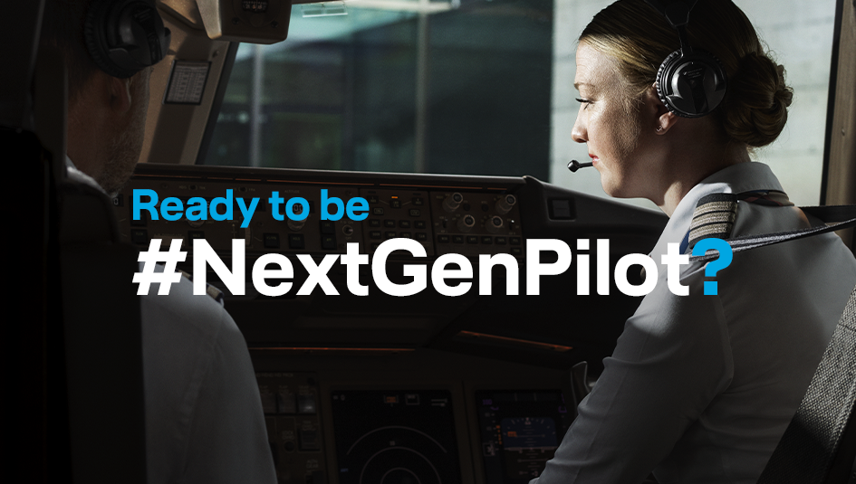 Two pilots are sitting in the cockpit of an aircraft, wearing headsets with microphones. The aircraft is on the ground.
