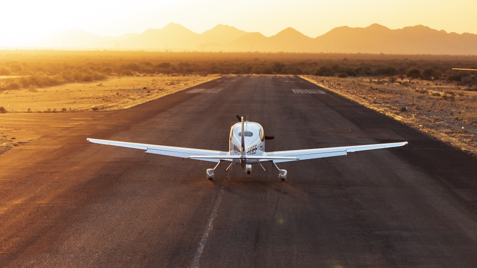 A Cirrus SR20 training aircraft is parked on a runway in the middle of the Arizona desert.